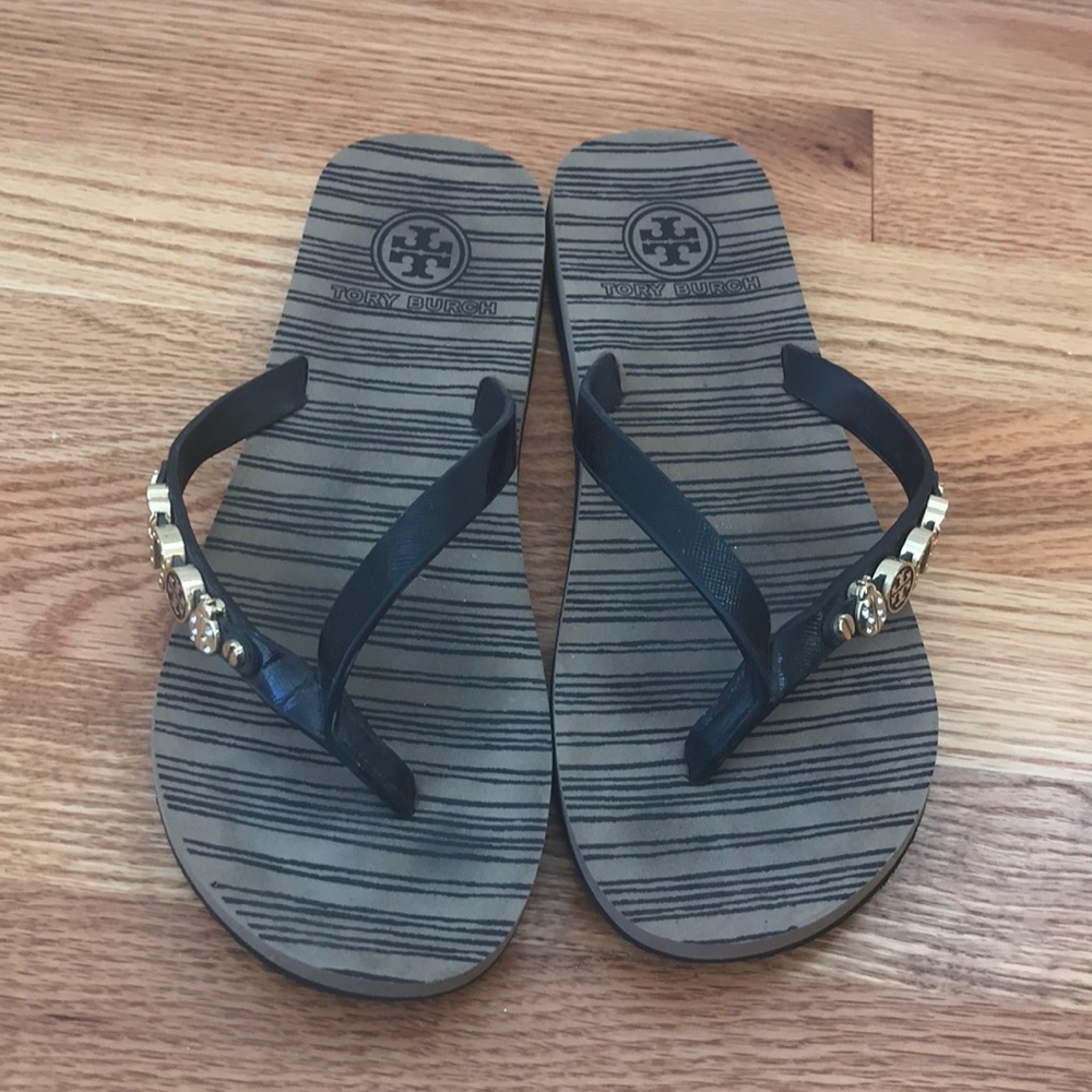 Tory Burch flip flops with gold charms